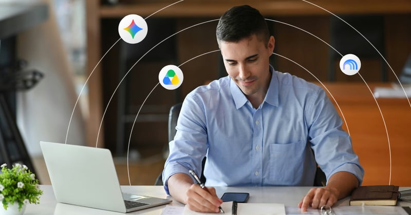 A young man works on some paperwork at his desk