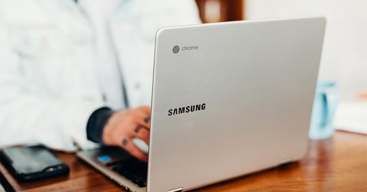 A person types on a Samsung Chromebook device