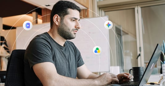 Man works on a laptop in a professional work setting 