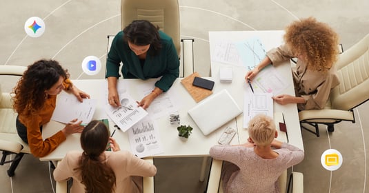 Four colleagues sit around a conference table for a team meeting 