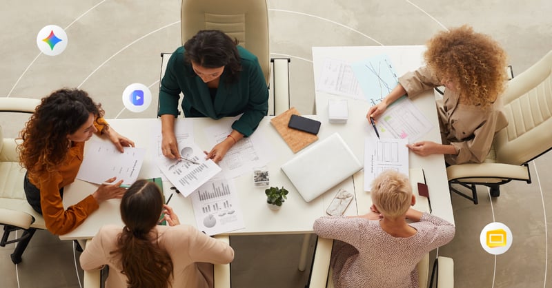 Four colleagues sit around a conference table for a team meeting 
