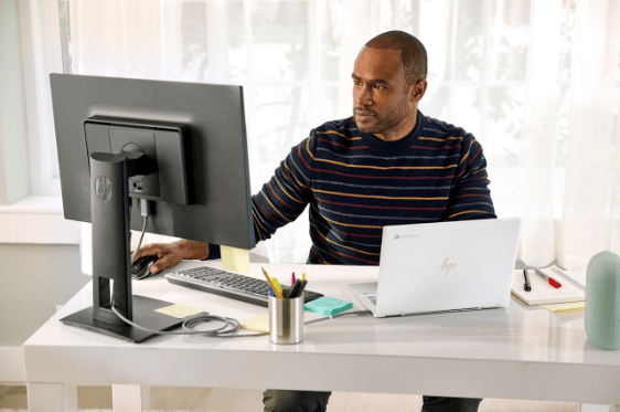 A man looking diligently at a computer monitor