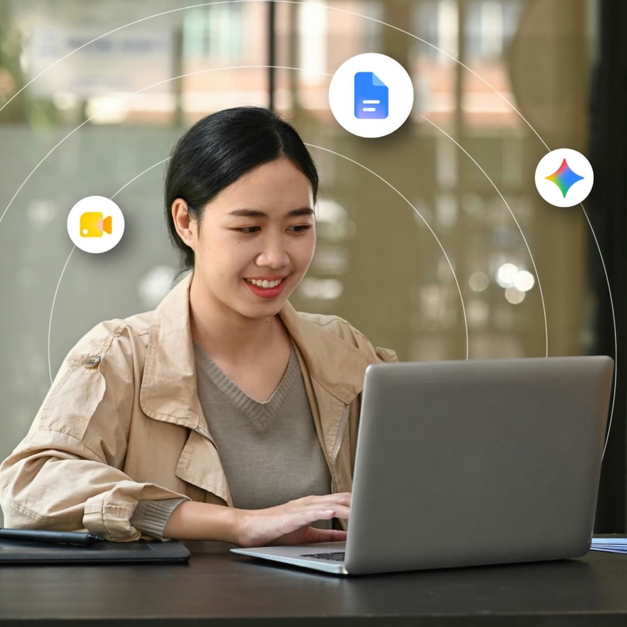 A young woman looking at her laptop screen and smiling