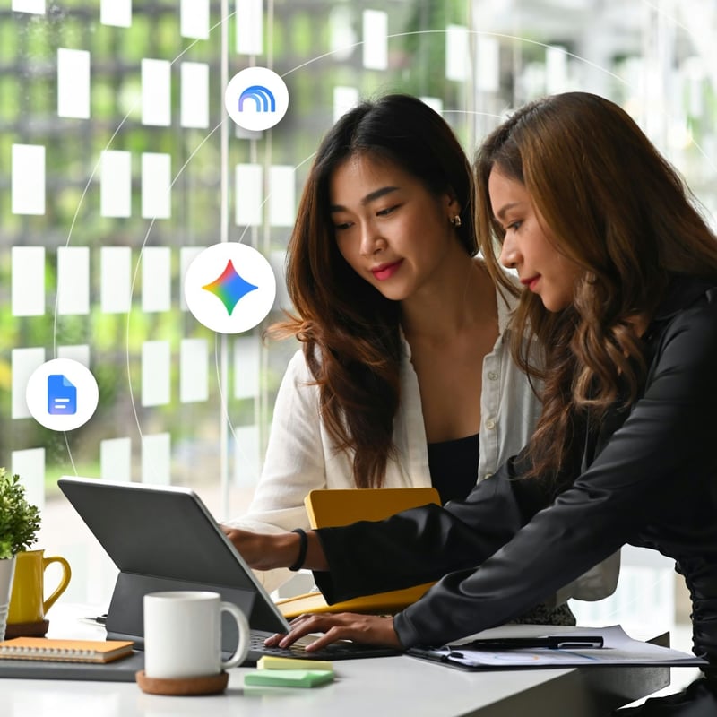 Two women review information on a laptop screen