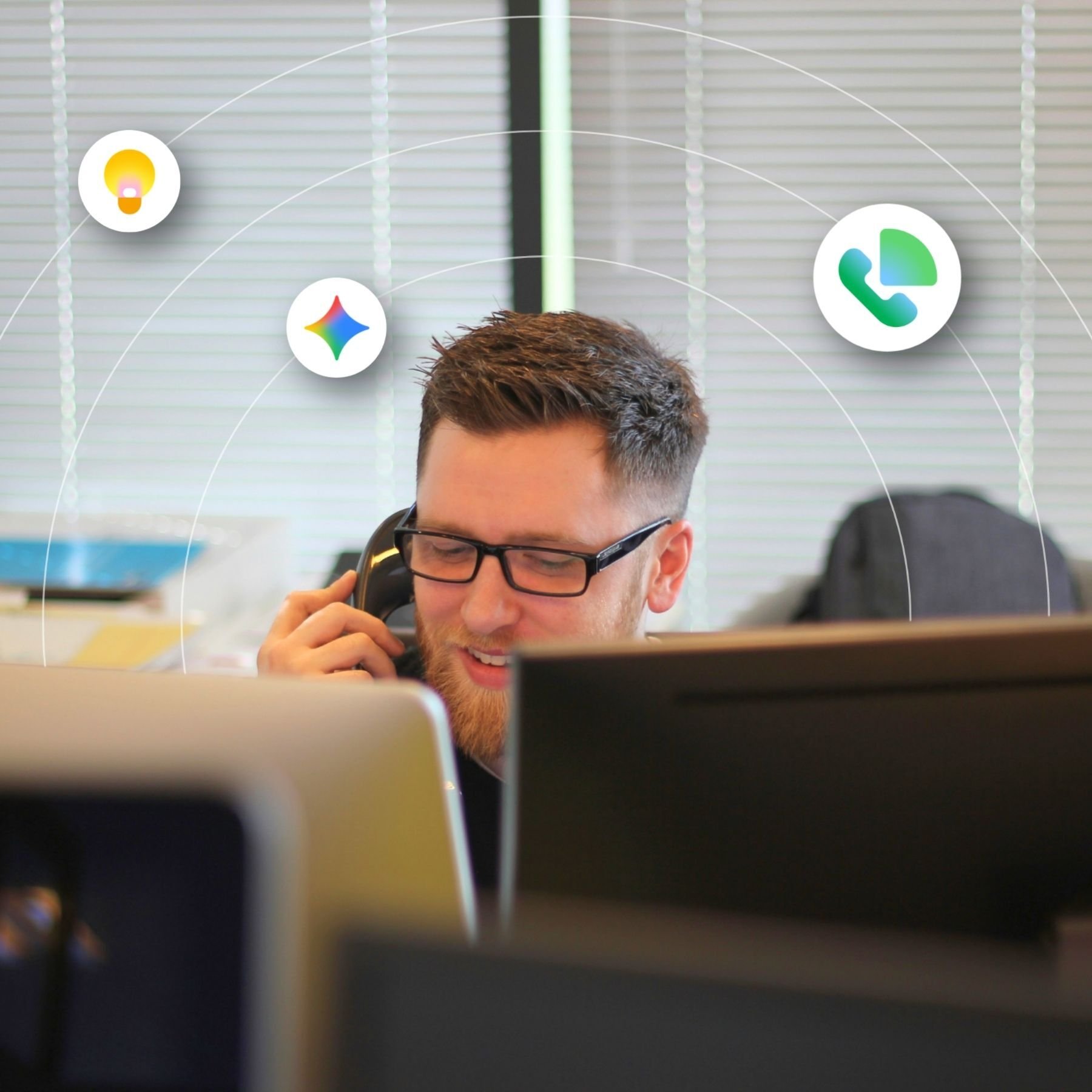 A man talks on his desk phone using Google Voice
