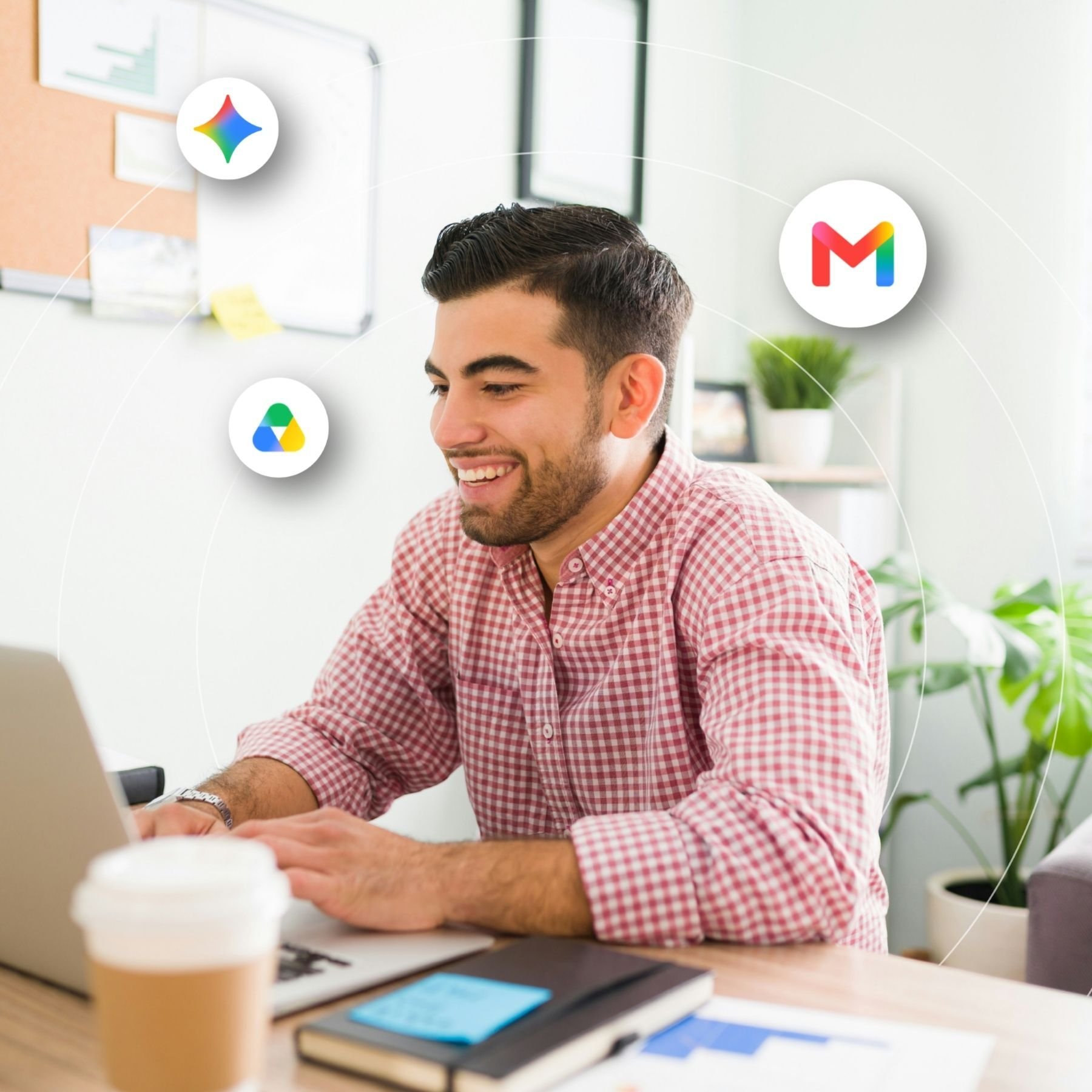 Man in a button down shirt smiling at a laptop screen